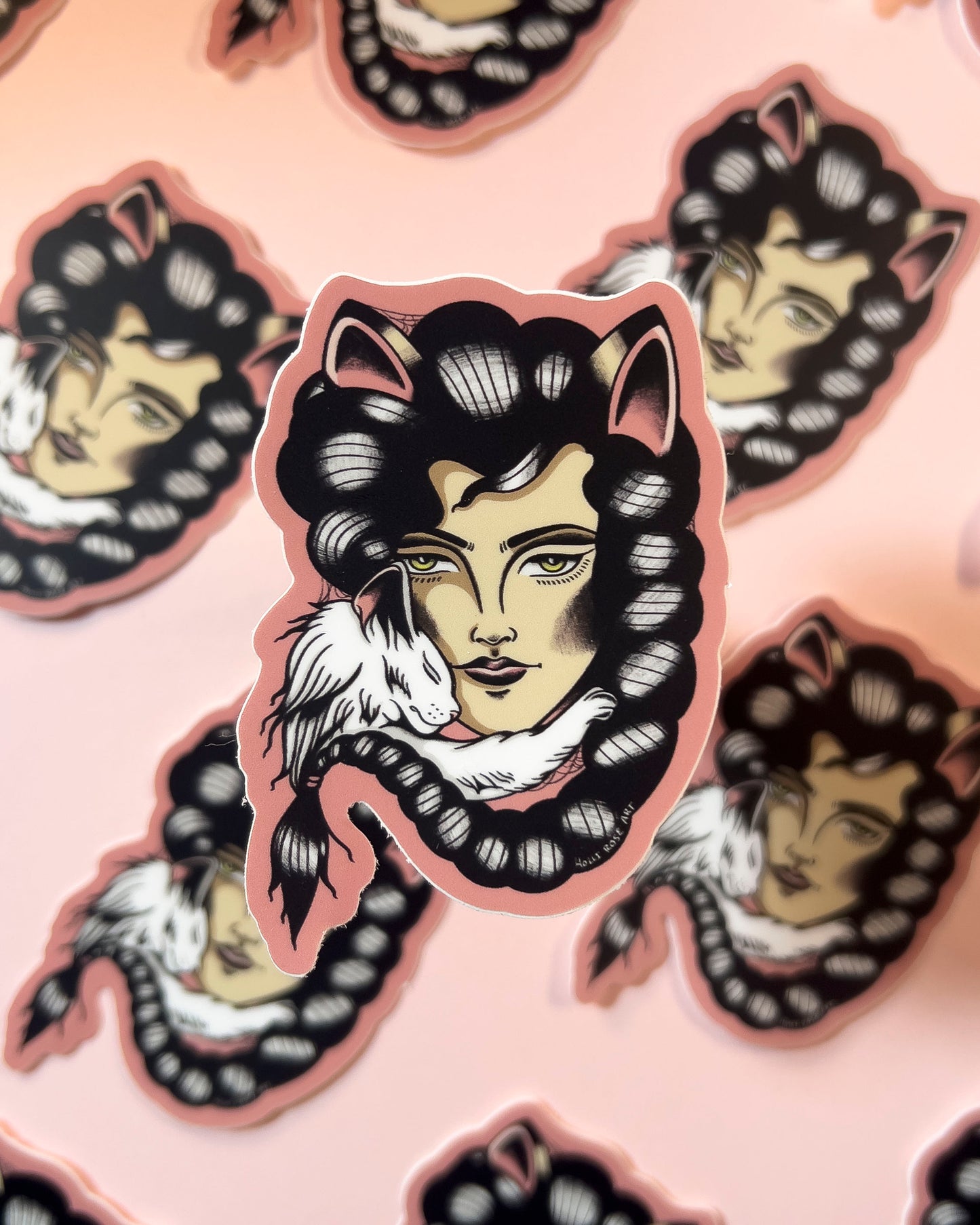 Sticker of a stylized face with cat ears on a pink background