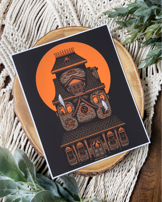 a haunted house with an orange moon behind it