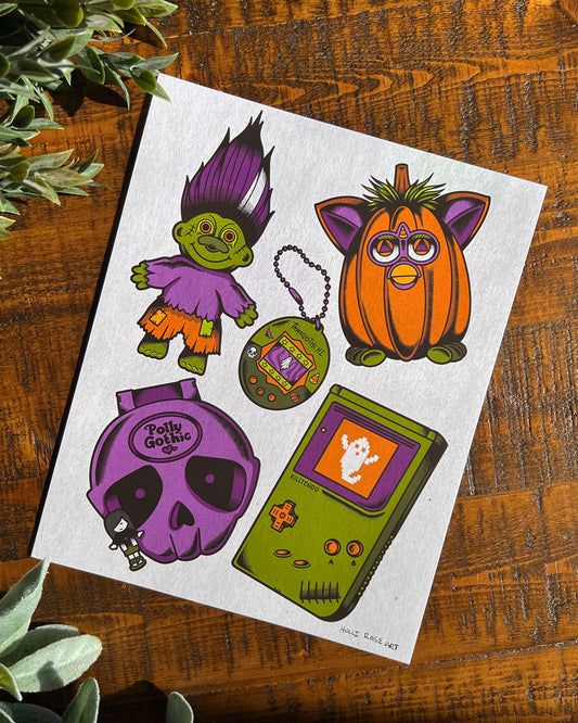 5 colorful Halloween-themed retro toys on a textured white background