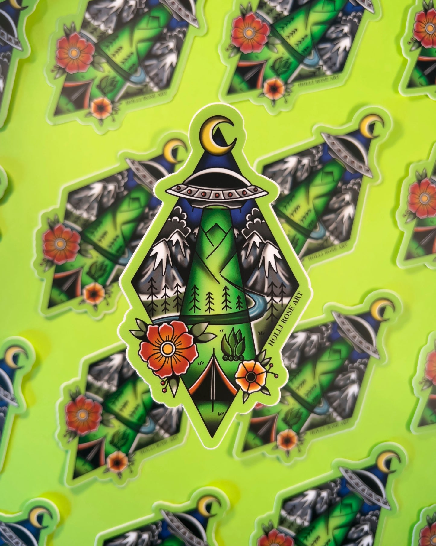 Decorative sticker with nature-themed alien abduction design on a green background