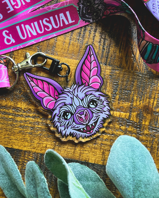 keychain of a bat face that is purple and pink