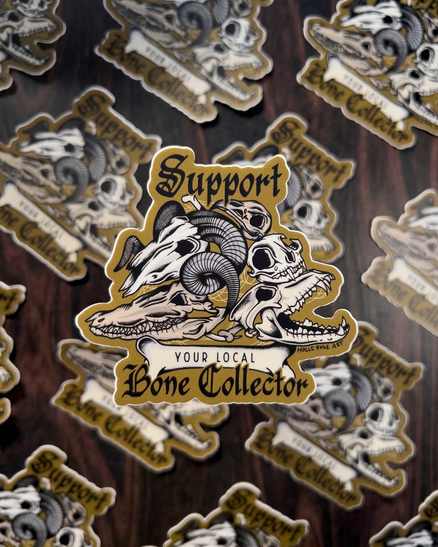 a sticker that says support your local bone collector with a stack of animal skulls