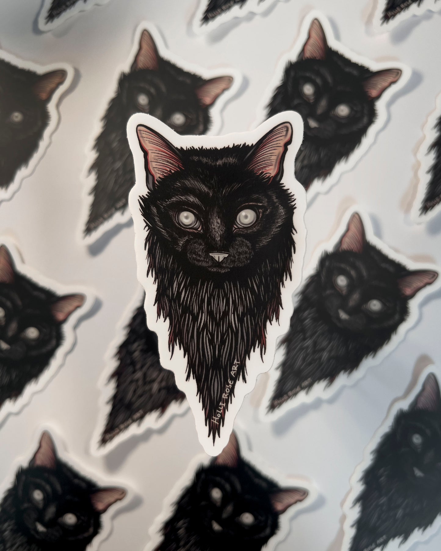 Sticker of a black cats head and blind eyes