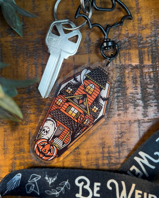 Decorative keychain with haunted house design