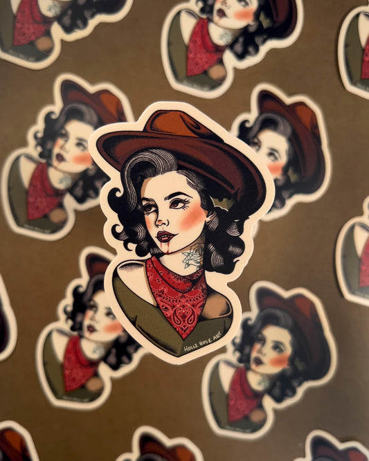sticker of a woman in a cowboy hat, with vampire teeth and blood running down her chin