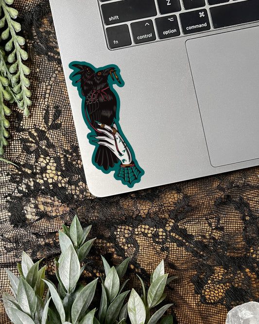 Decorative sticker with a 2 headed crow on a laptop keyboard
