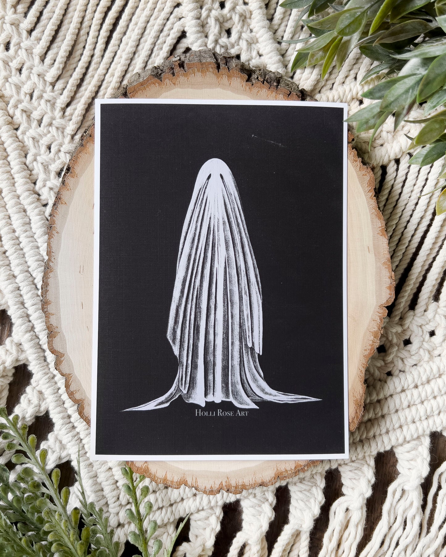 print of a white sheet ghost on a black background