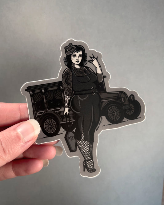 Goth girl sticker wearing a black dress with a black old vehicle behind her