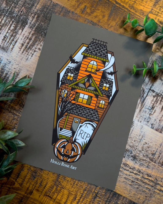 a haunted house in a coffin shape print
