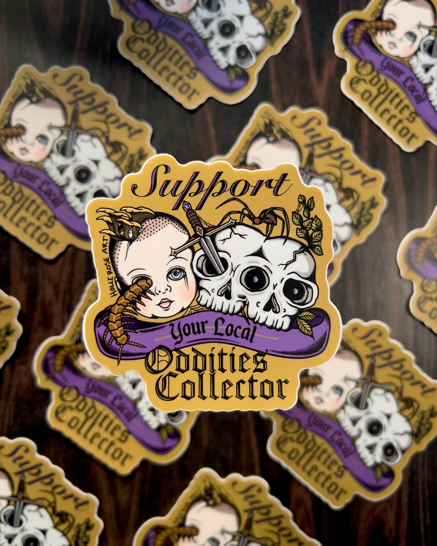 a sticker that says support your local oddities collector with a doll head, double headed skull, and bugs