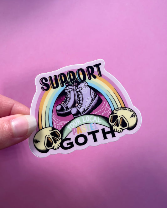 a sticker that says support your local pastel goth with purple goth boots, a rainbow and a skull