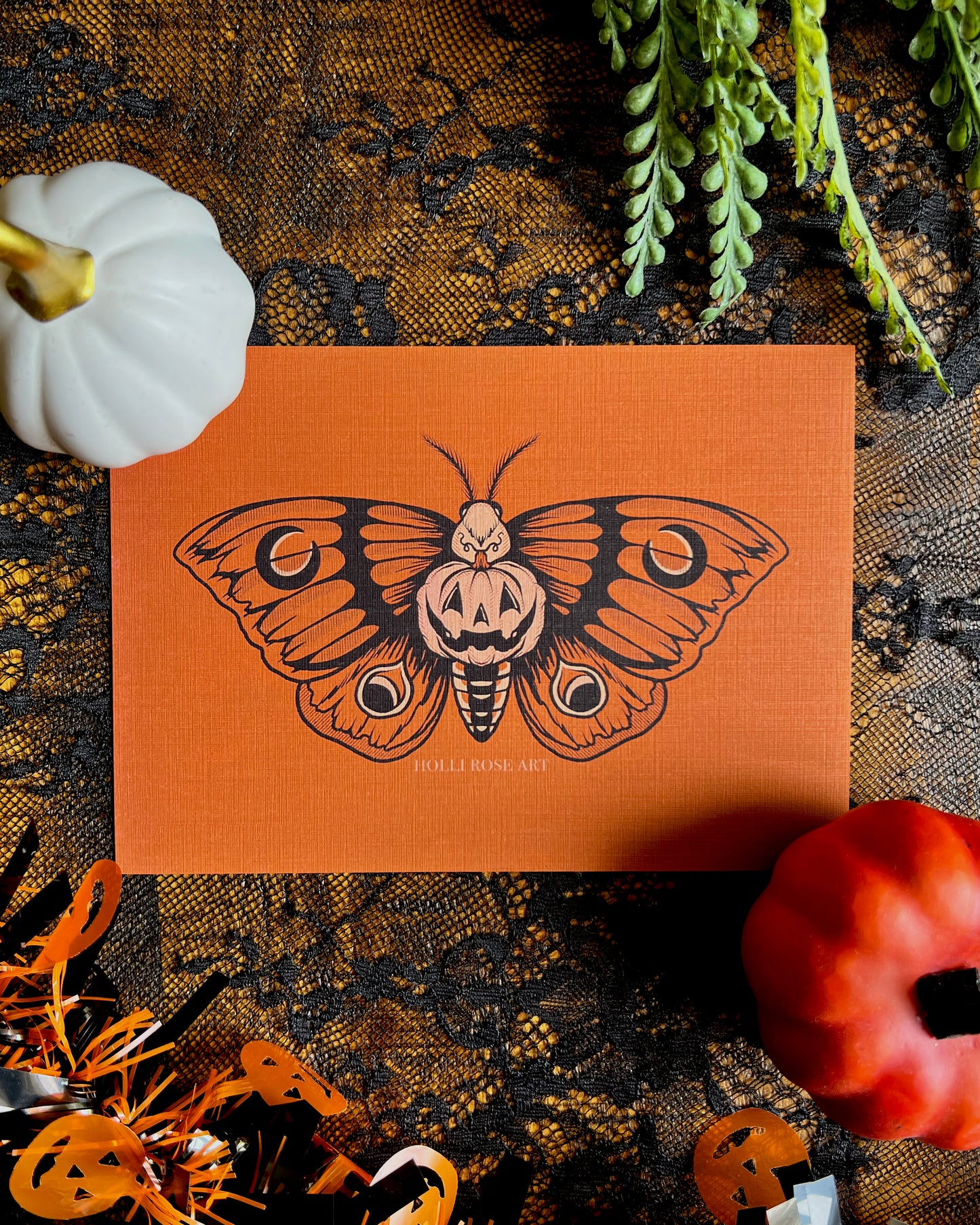 a print with a moth and a pumpkin in the middle of its body smiling