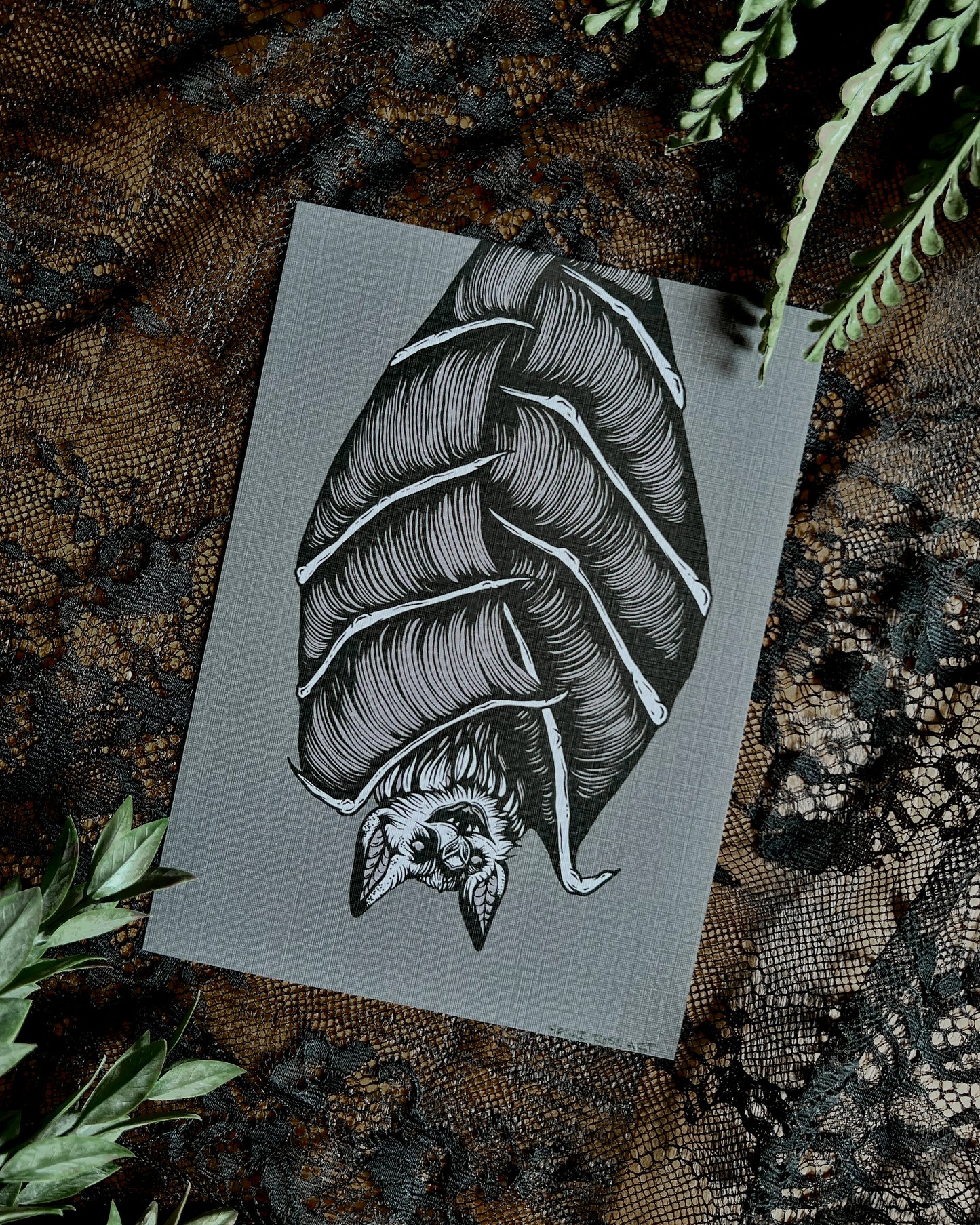 art print of a bat hanging upside down