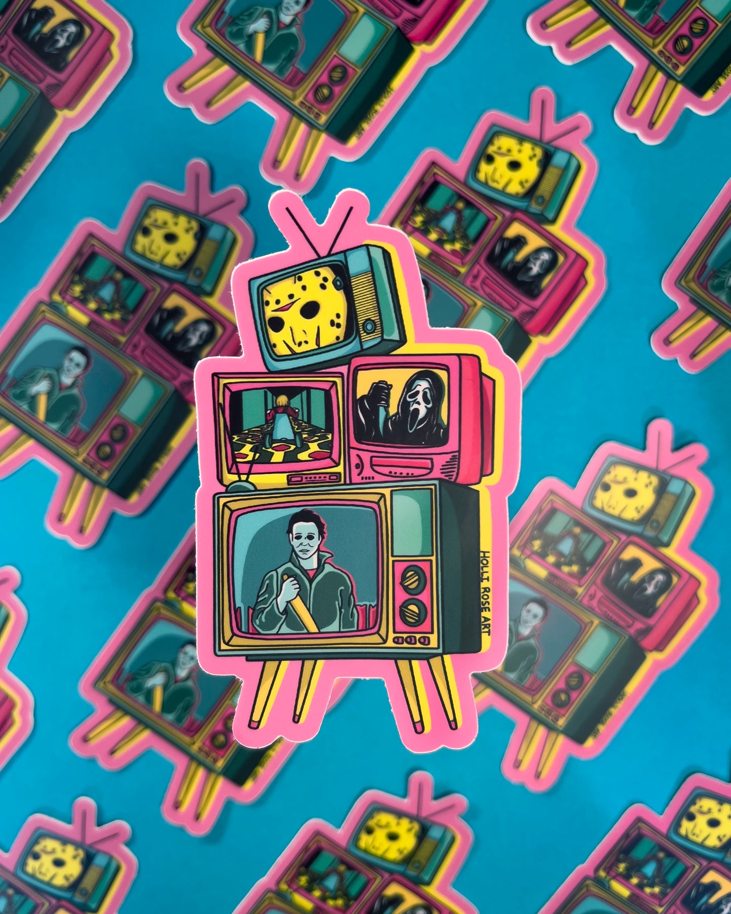 A sticker with tvs stacked and horror characters in pink, blues and yellows