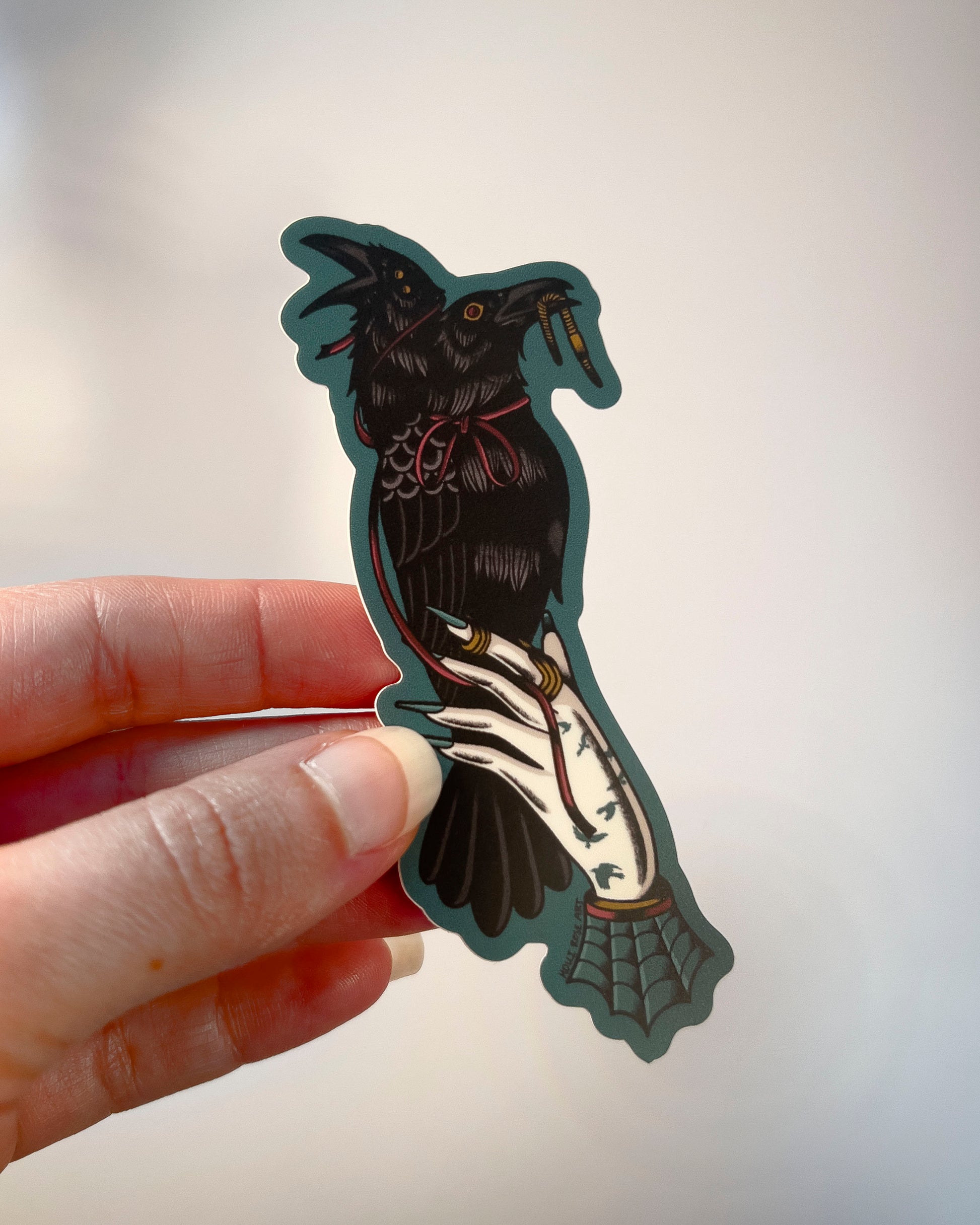 2 headed raven perched on a hand sticker