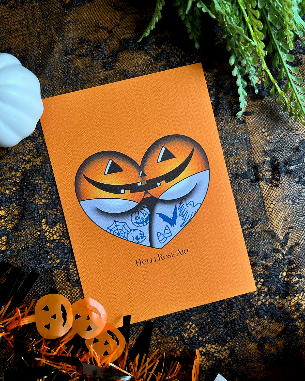 a print of a booty in the shape of a heart, wearing jack o lantern underwear
