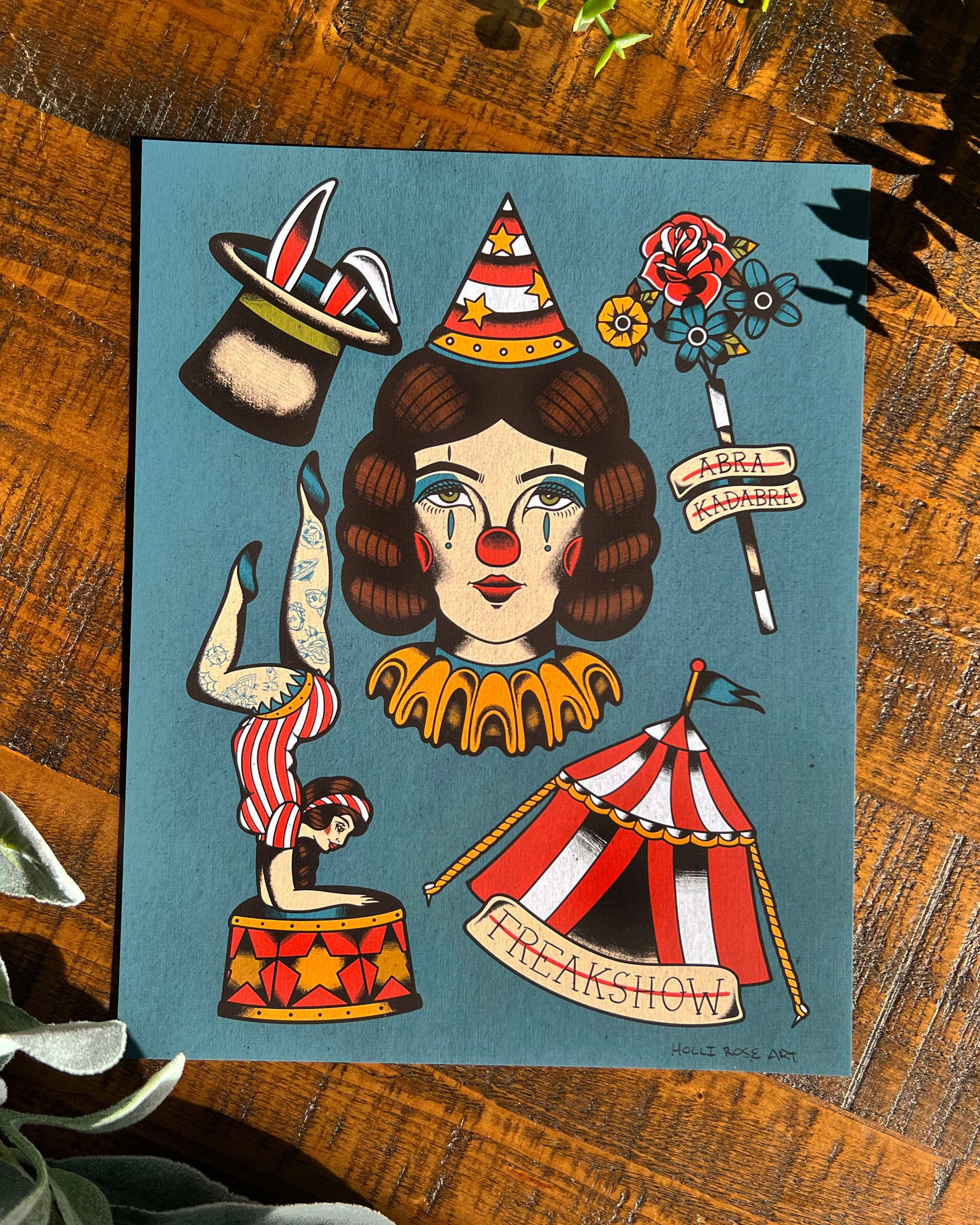 Illustration of a circus-themed character with tattoos and props on a blue background, placed on a wooden surface.