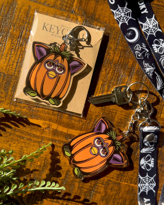 Pumpkin-shaped keychain with cat ears and eyes 