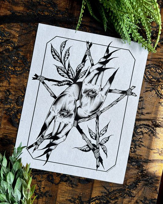 a print with Witchy hands with an eye in the center of the palm and sticks forming a witchy star around it and leaves