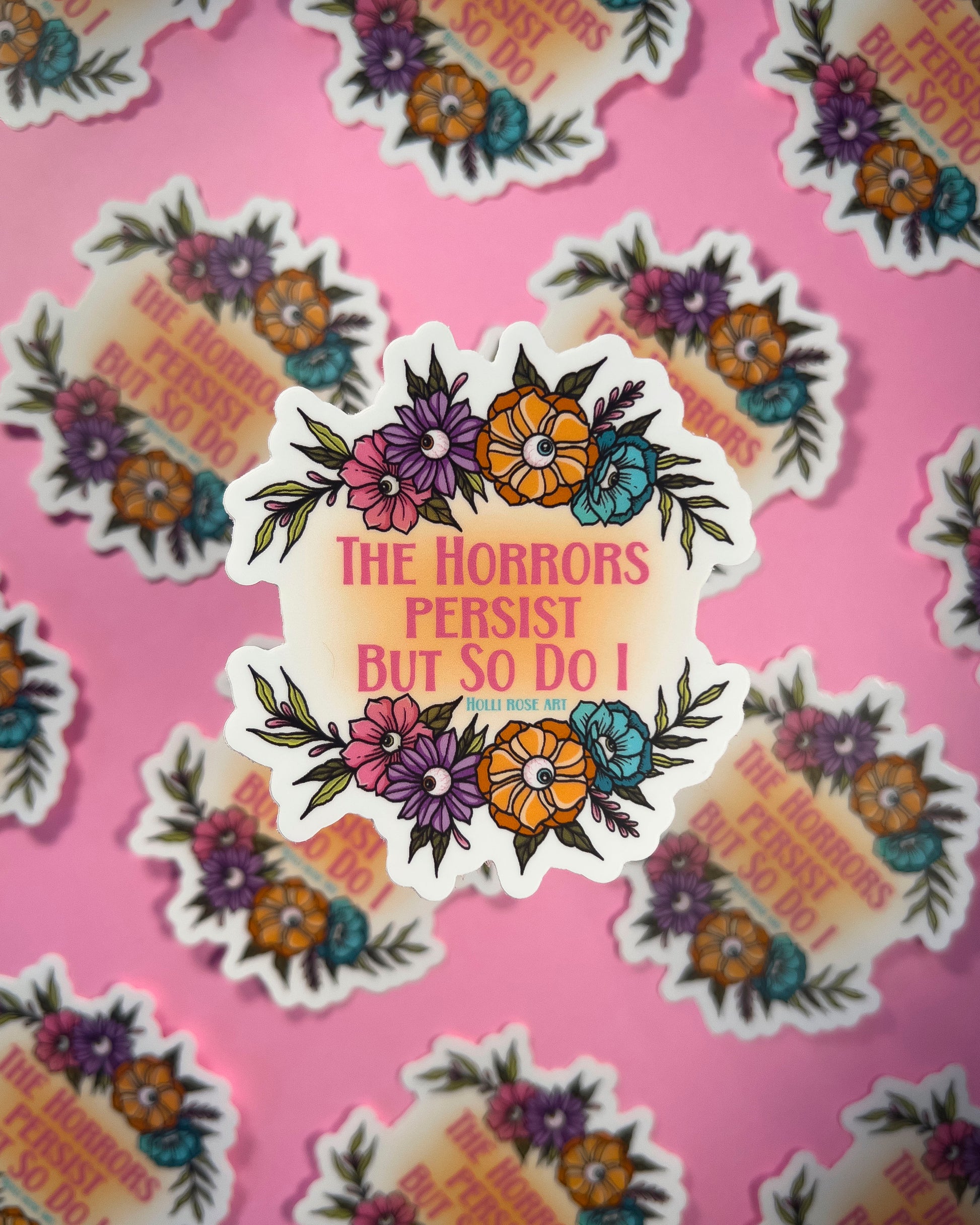 Sticker with floral design and text 'The Horrors Persist But So Do I' on a pink background