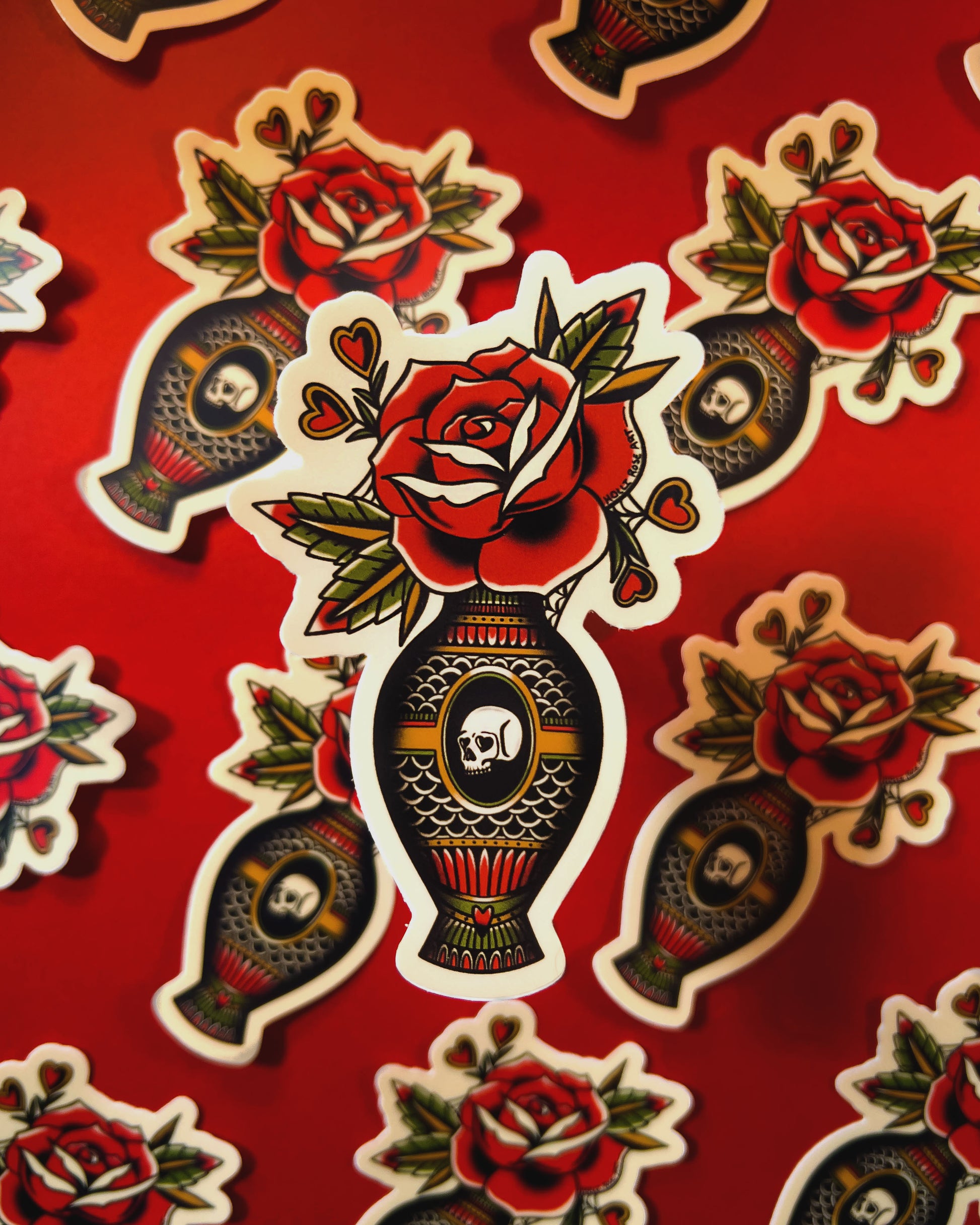 Decorative stickers with roses and skulls on a red background