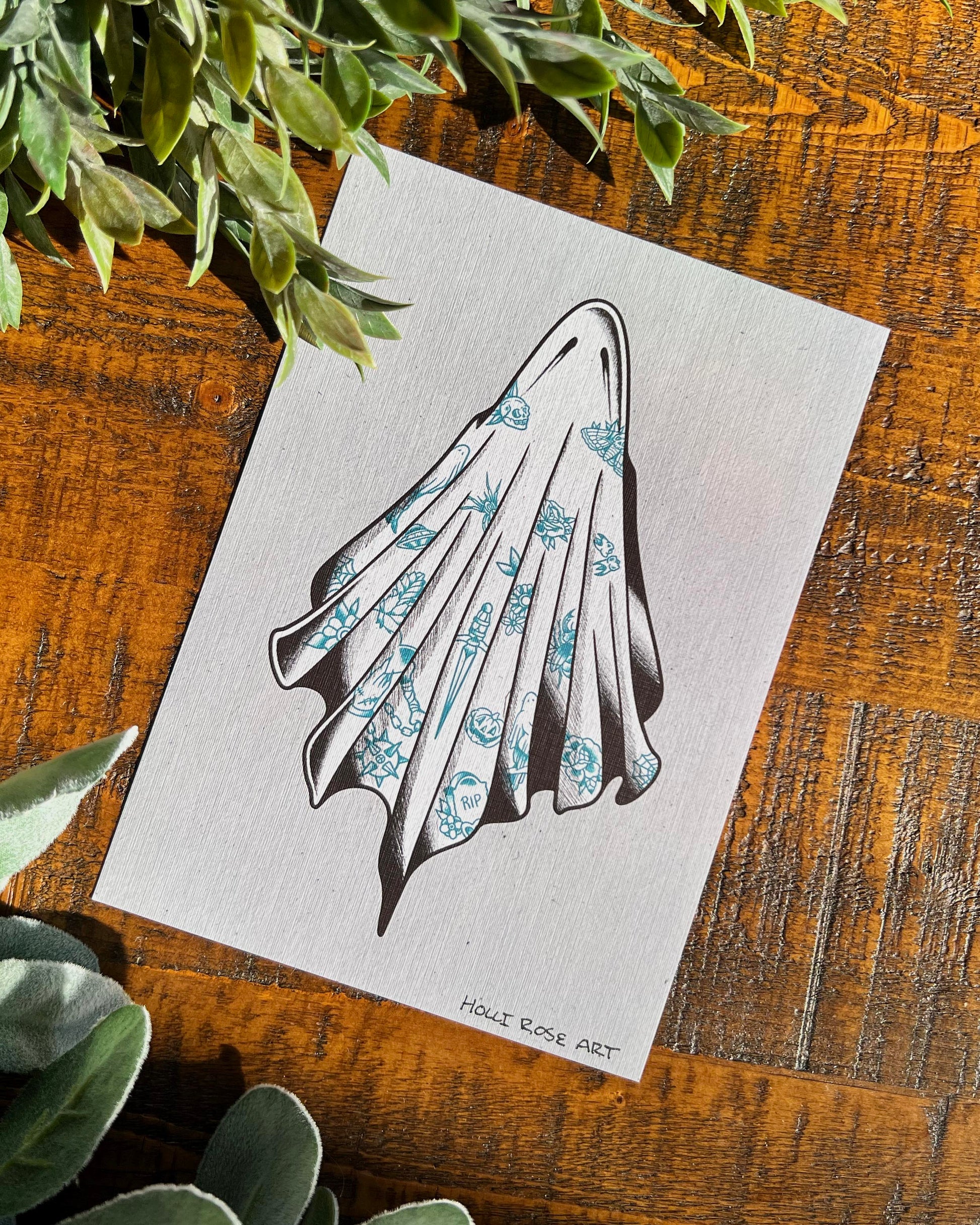 An art print with a ghost covered in tattoos, on a grey background