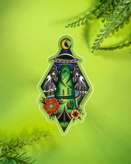 Decorative sticker with nature-themed alien abduction design on a green background
