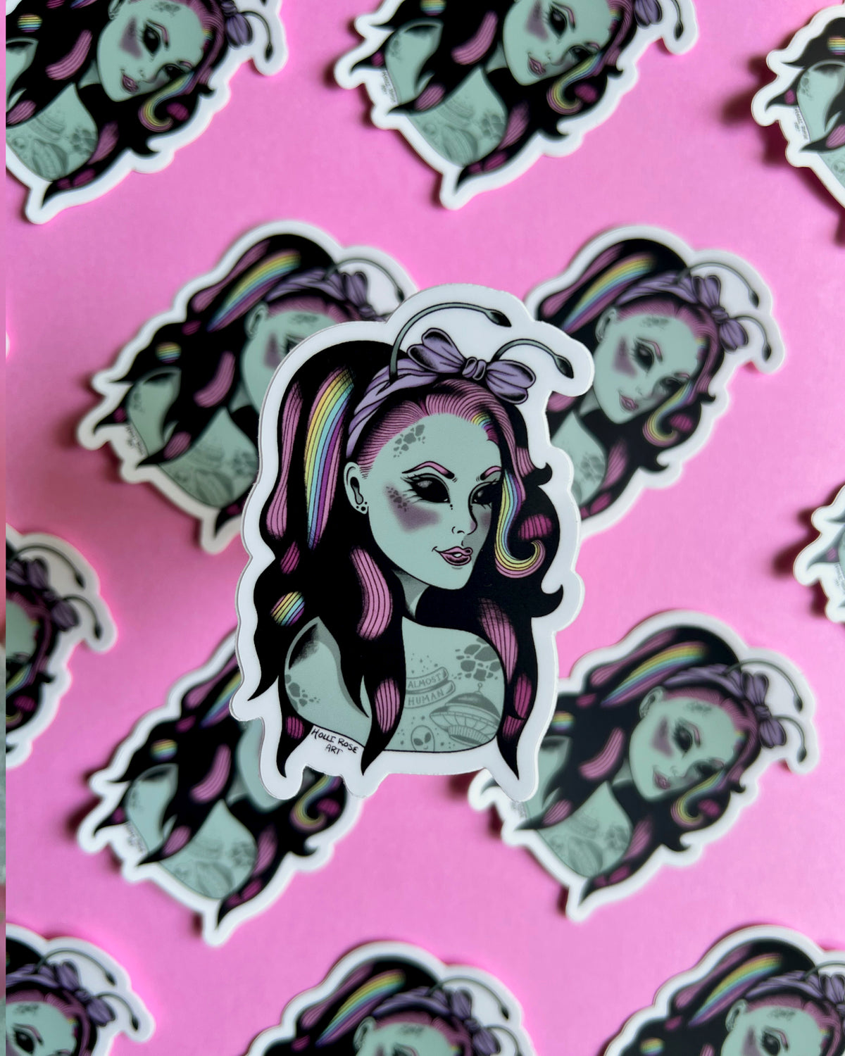 a sticker of an alien girl with rainbow and pink hair and space tattoos