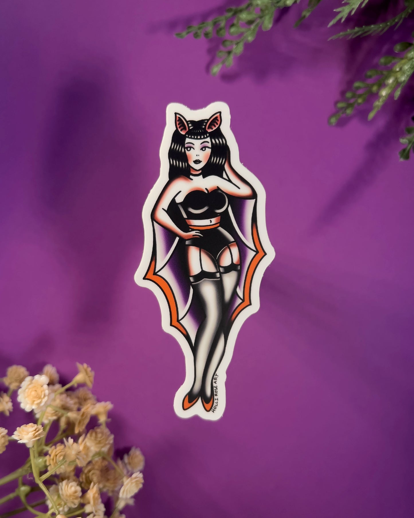 sticker of a pinup girl in a bat costume