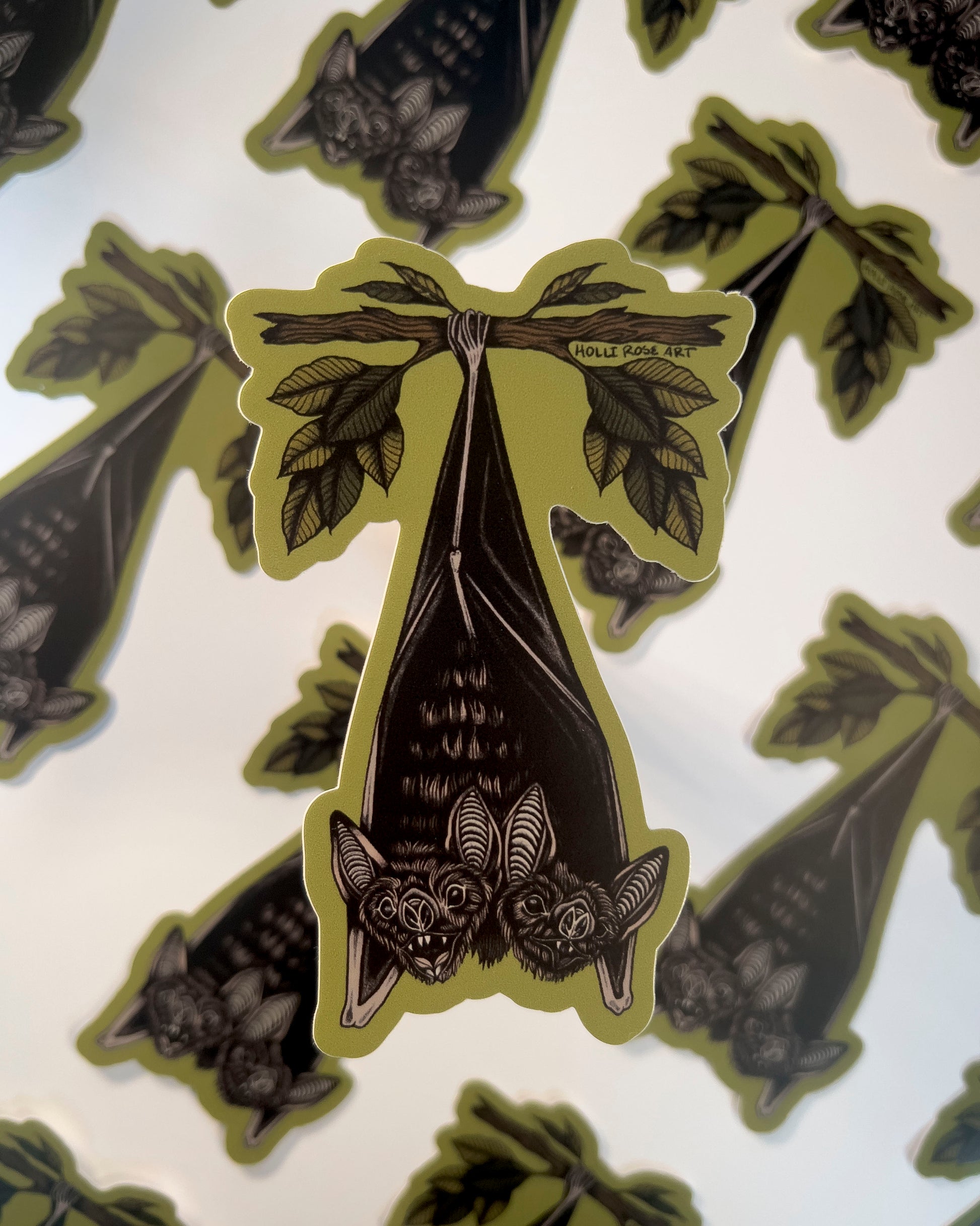 double headed bat hanging upside down from a tree branch sticker