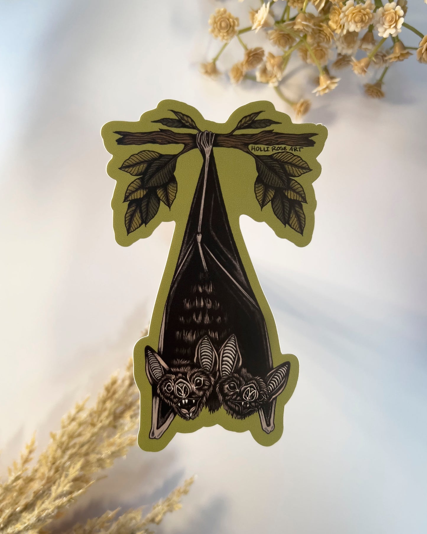 double headed bat hanging upside down from a tree branch sticker