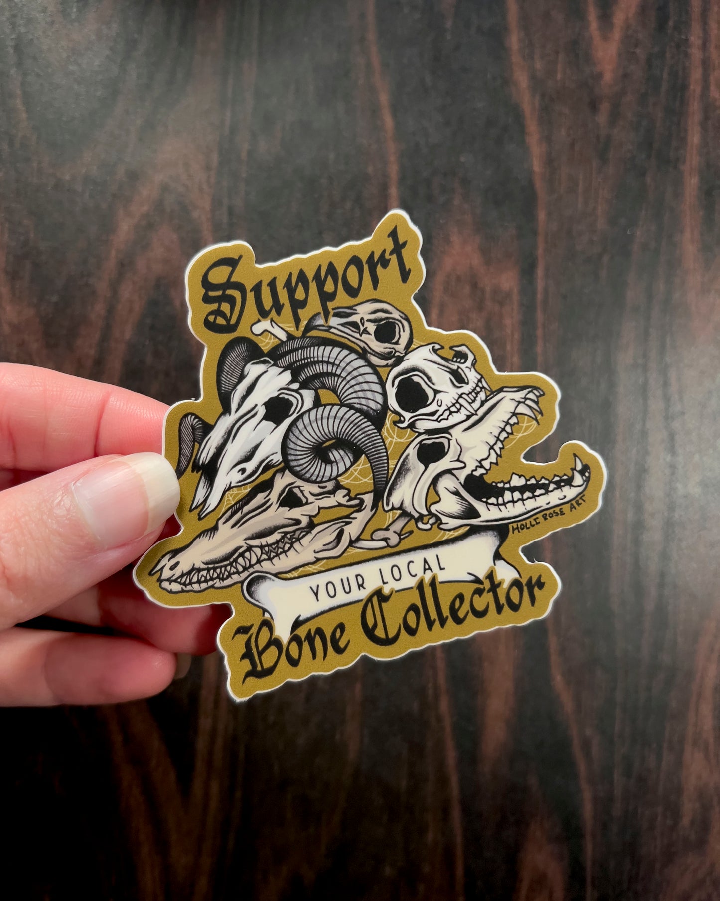 a sticker that says support your local bone collector with a stack of animal skulls 