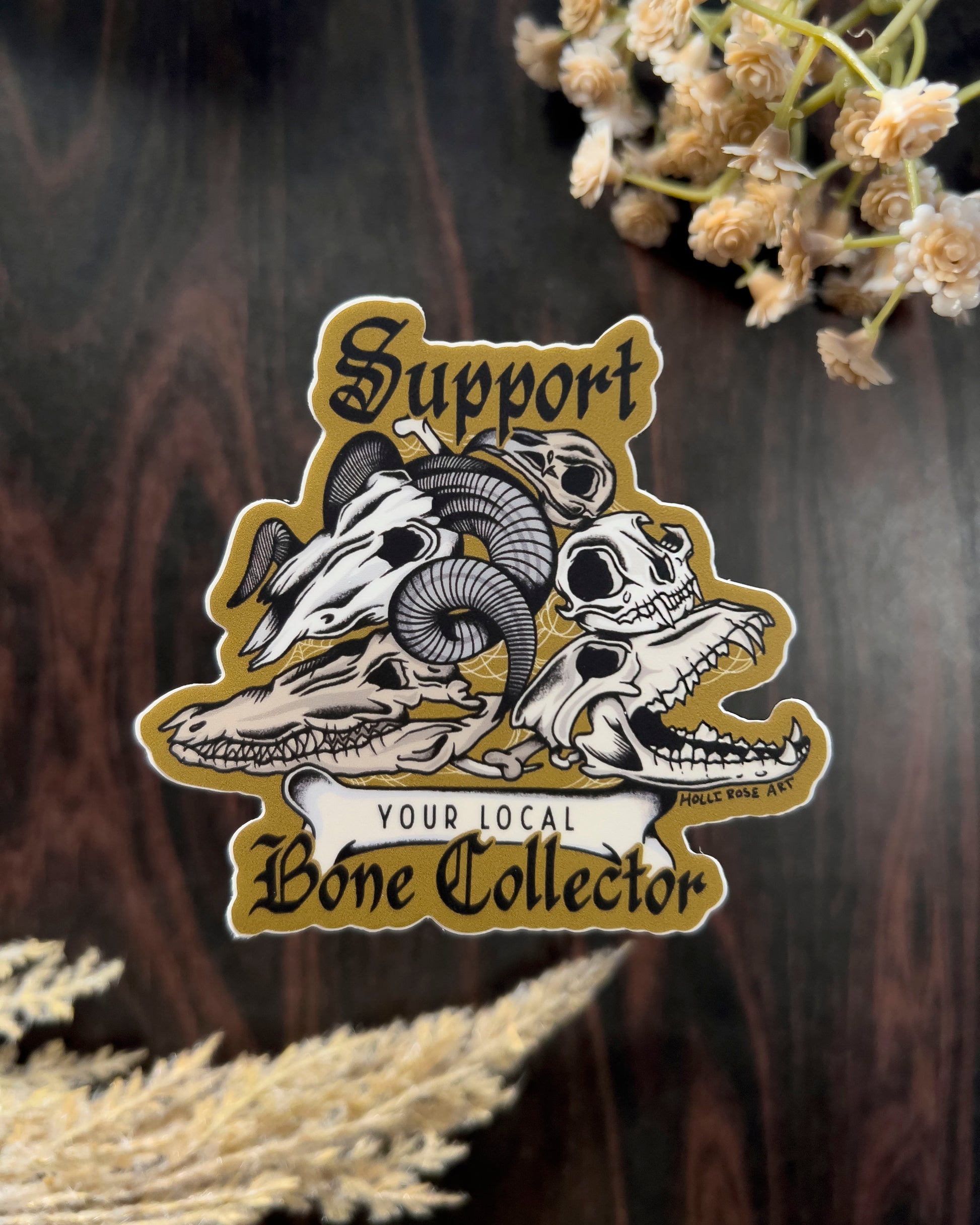 a sticker that says support your local bone collector with a stack of animal skulls 