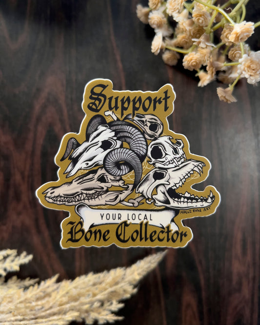 a sticker that says support your local bone collector with a stack of animal skulls 