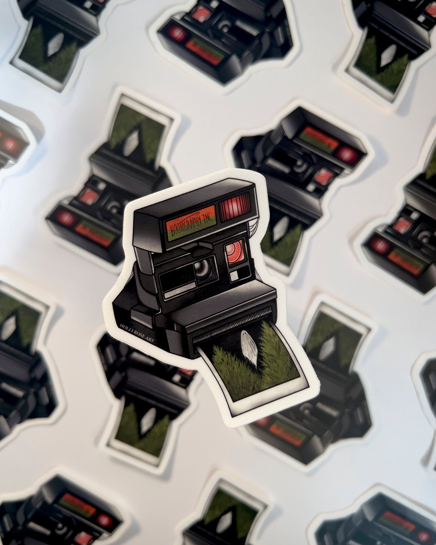 old style camera with the saying "bootography" on it and a polaroid coming  out of it with a picture of a ghost