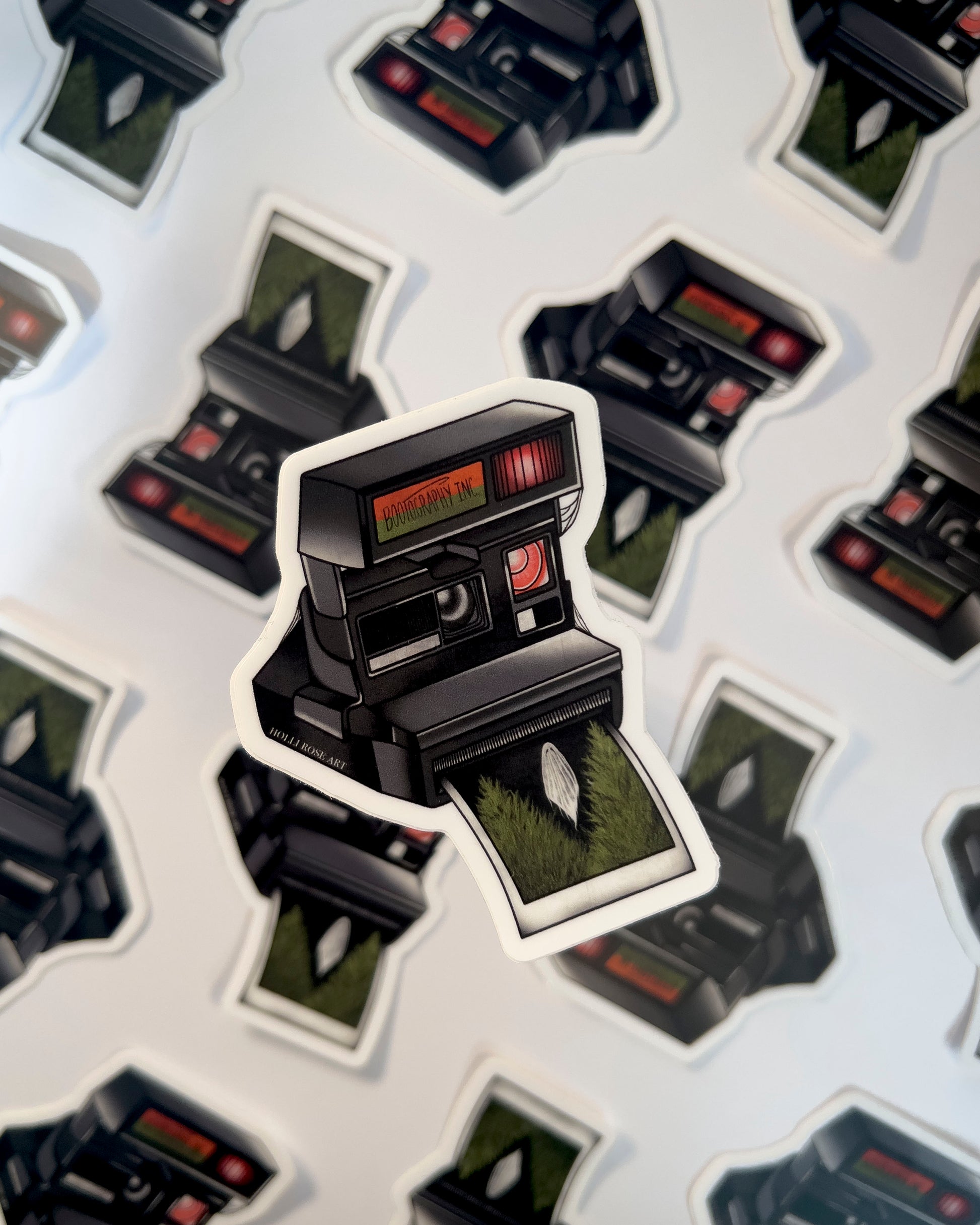 old style camera with the saying "bootography" on it and a polaroid coming  out of it with a picture of a ghost