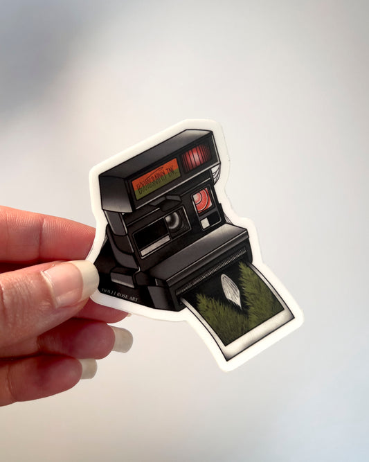 old style camera with the saying "bootography" on it and a polaroid coming  out of it with a picture of a ghost