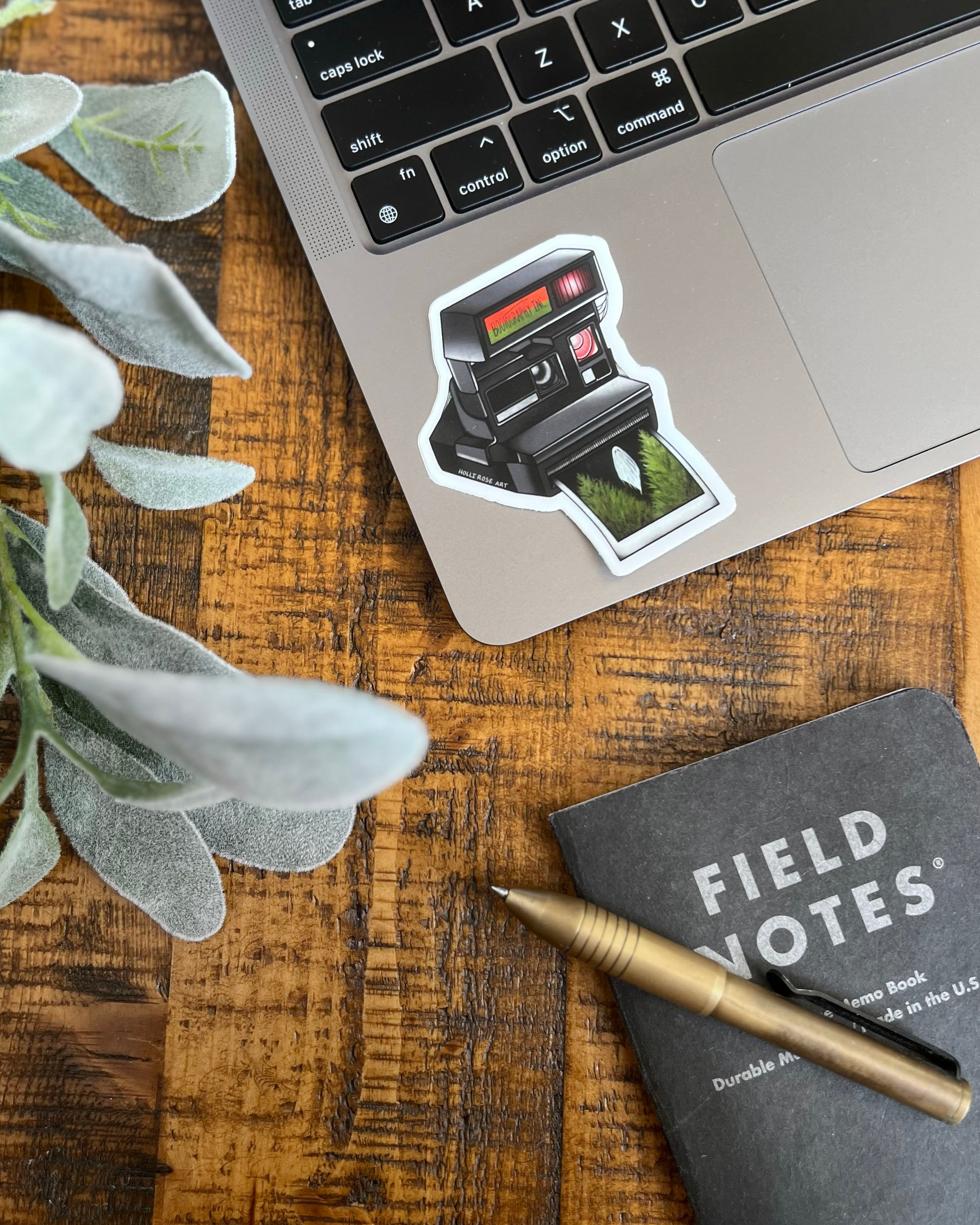 old style camera with the saying "bootography" on it and a polaroid coming  out of it with a picture of a ghost