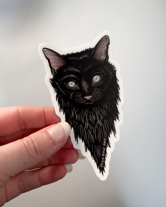 Sticker of a black cats head and blind eyes