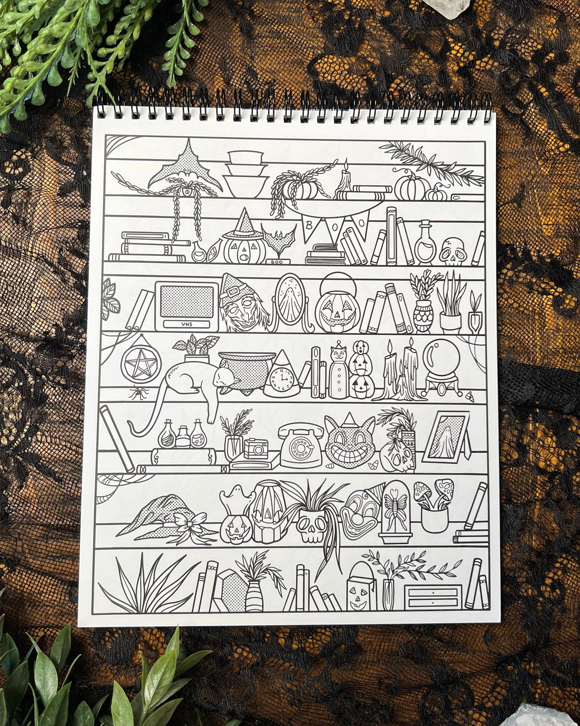 a coloring page featuring shelves with halloween themed trinkets