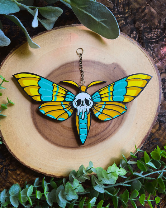 Decorative hand painted moth with skull design on a white background