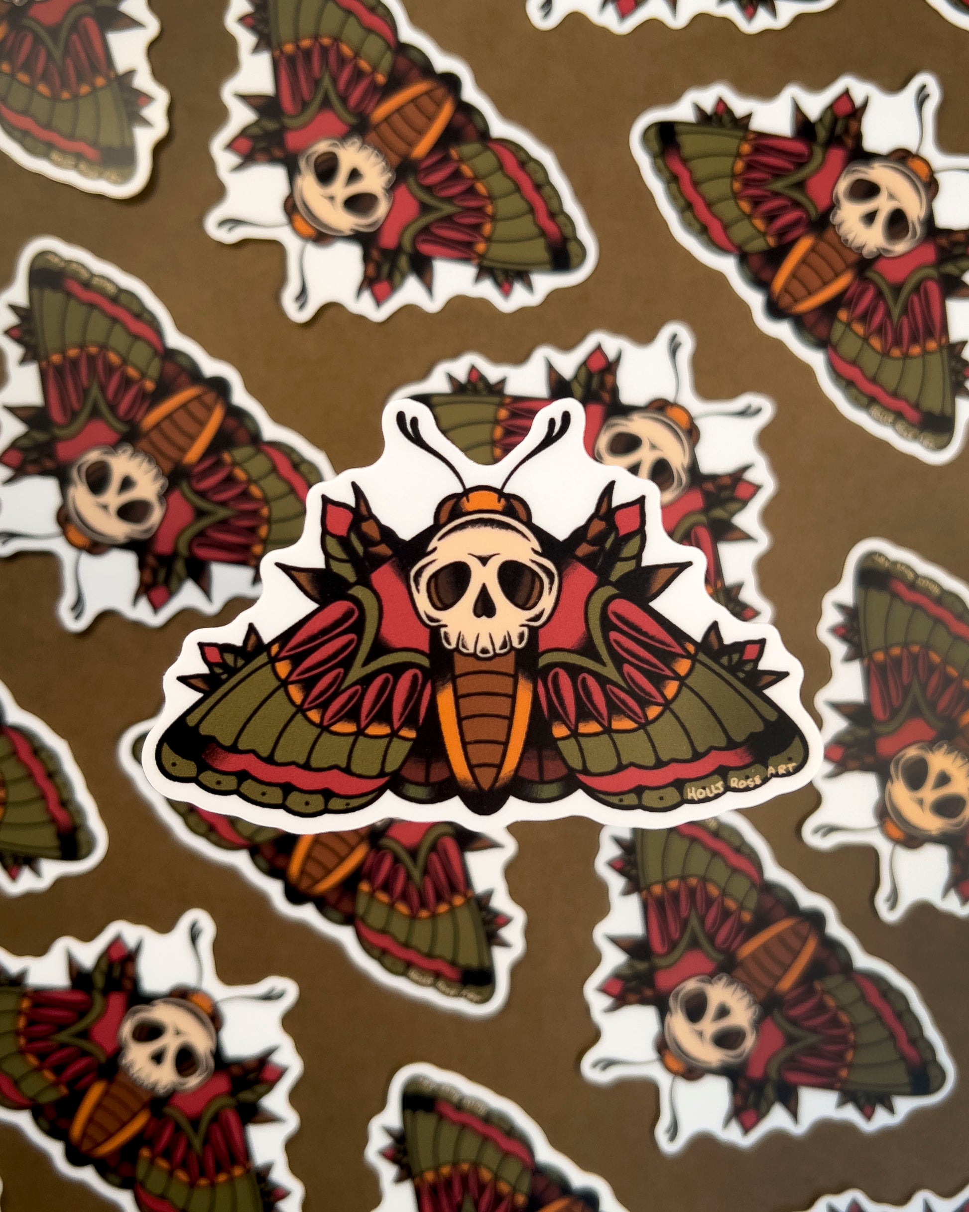 sticker of a moth with a skull on it's back