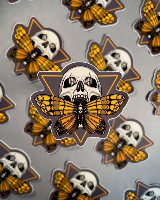 Pattern of butterfly and skull designs on a gray background