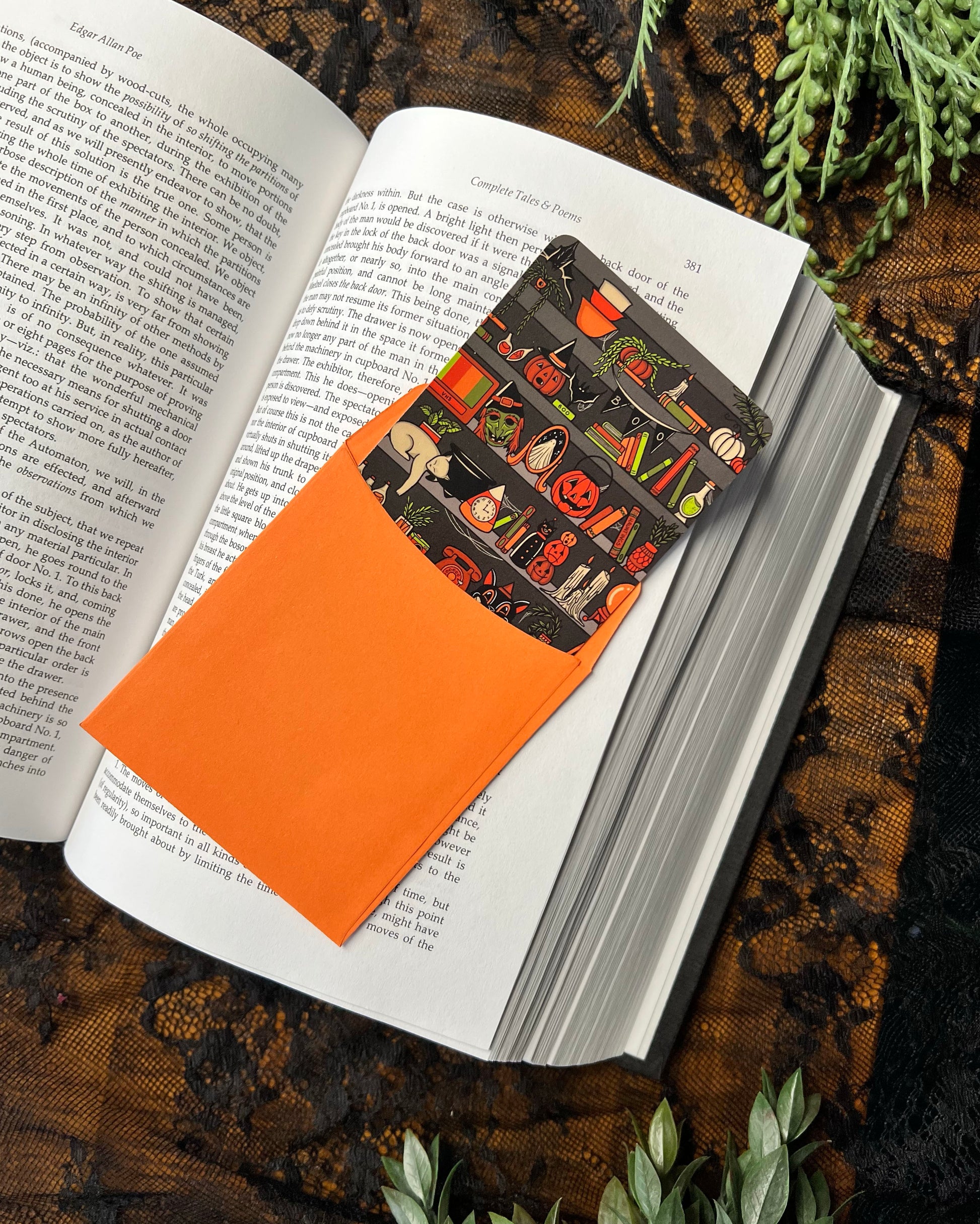 a halloween bookmark in an orange bookmark sleeve