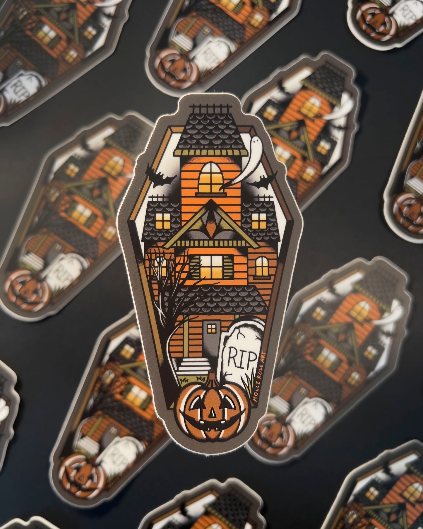 sticker shaped like a coffin with a haunted house inside