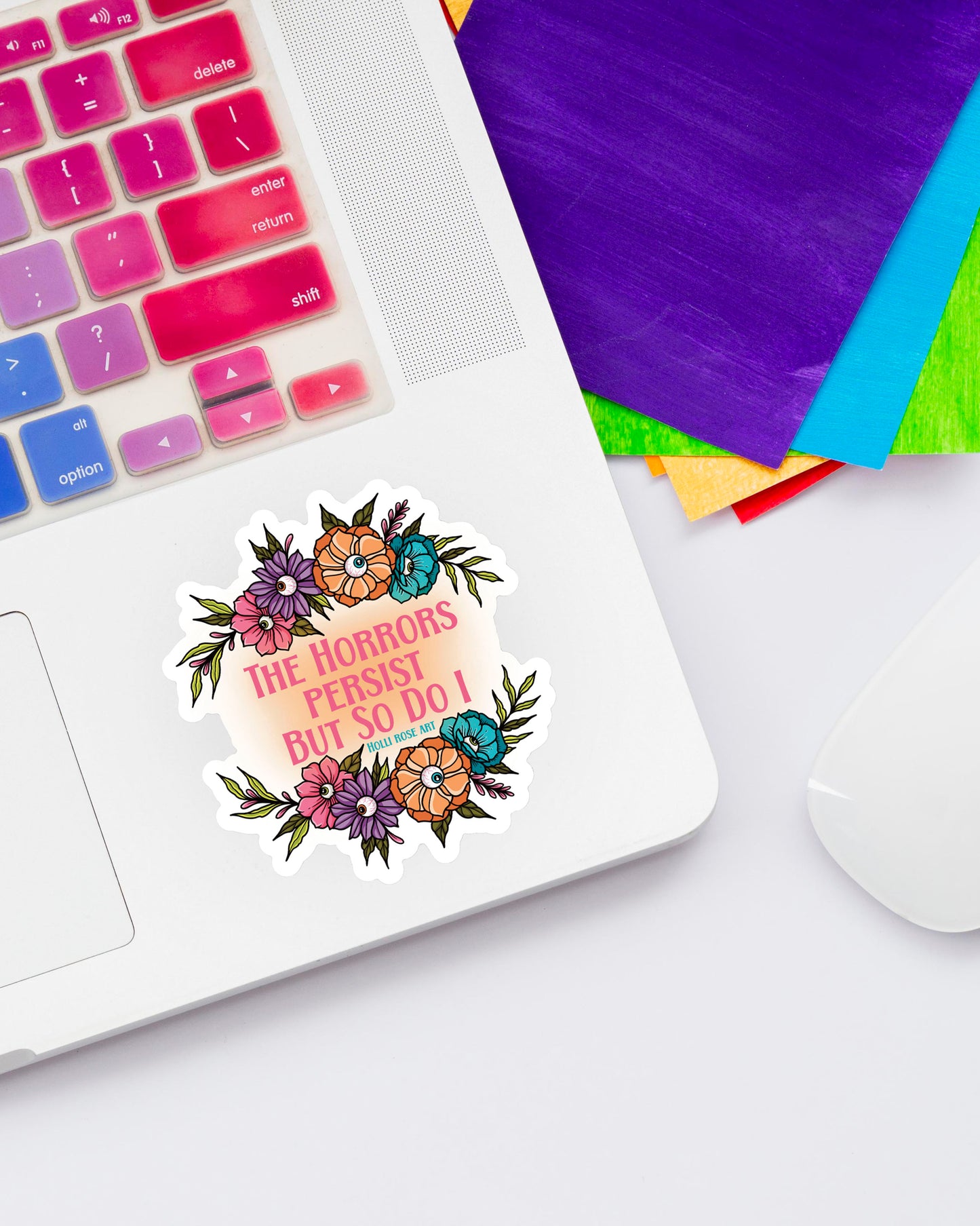 Sticker with floral design and text on a laptop
