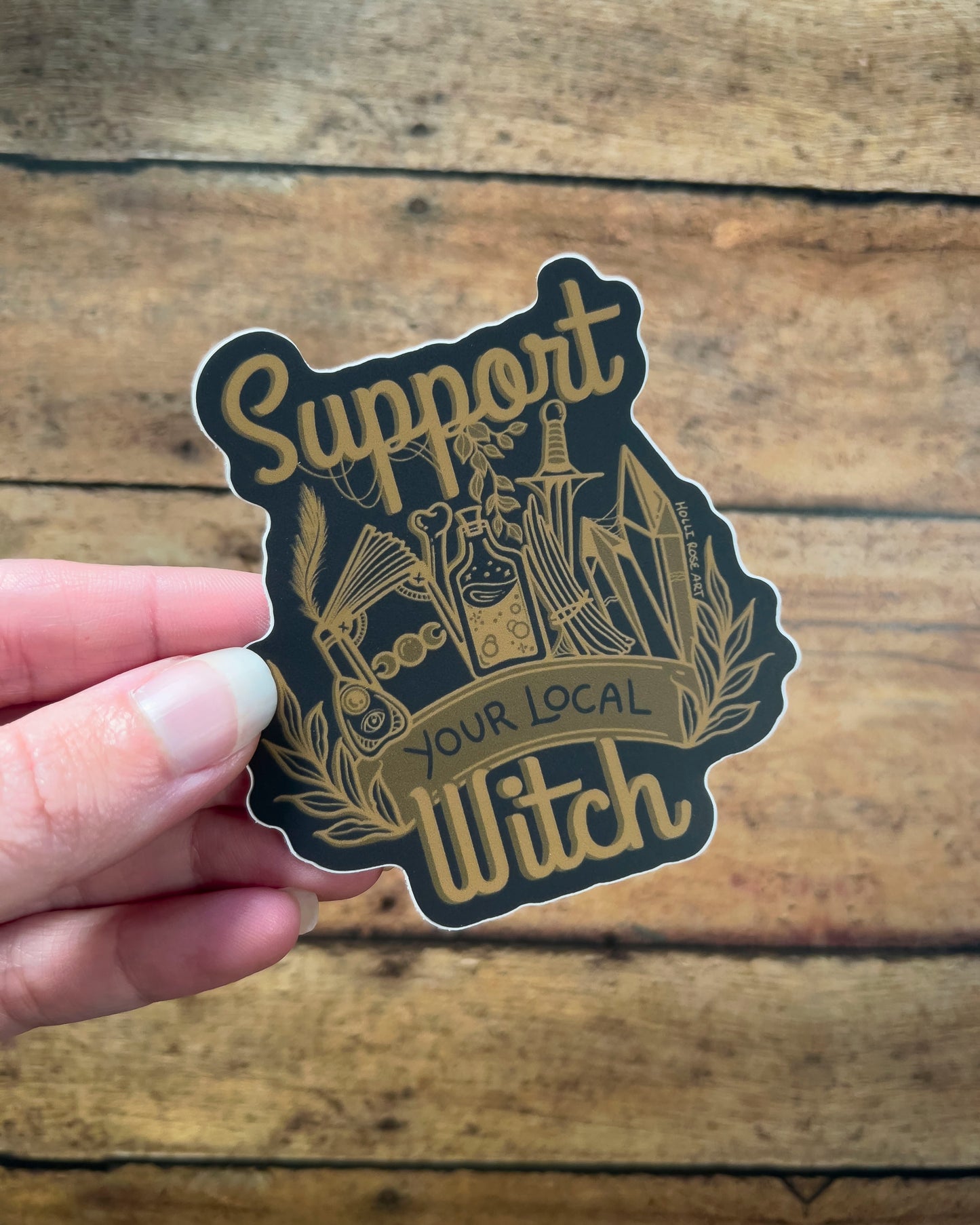 a sticker that says support your local witch with witchy elements 