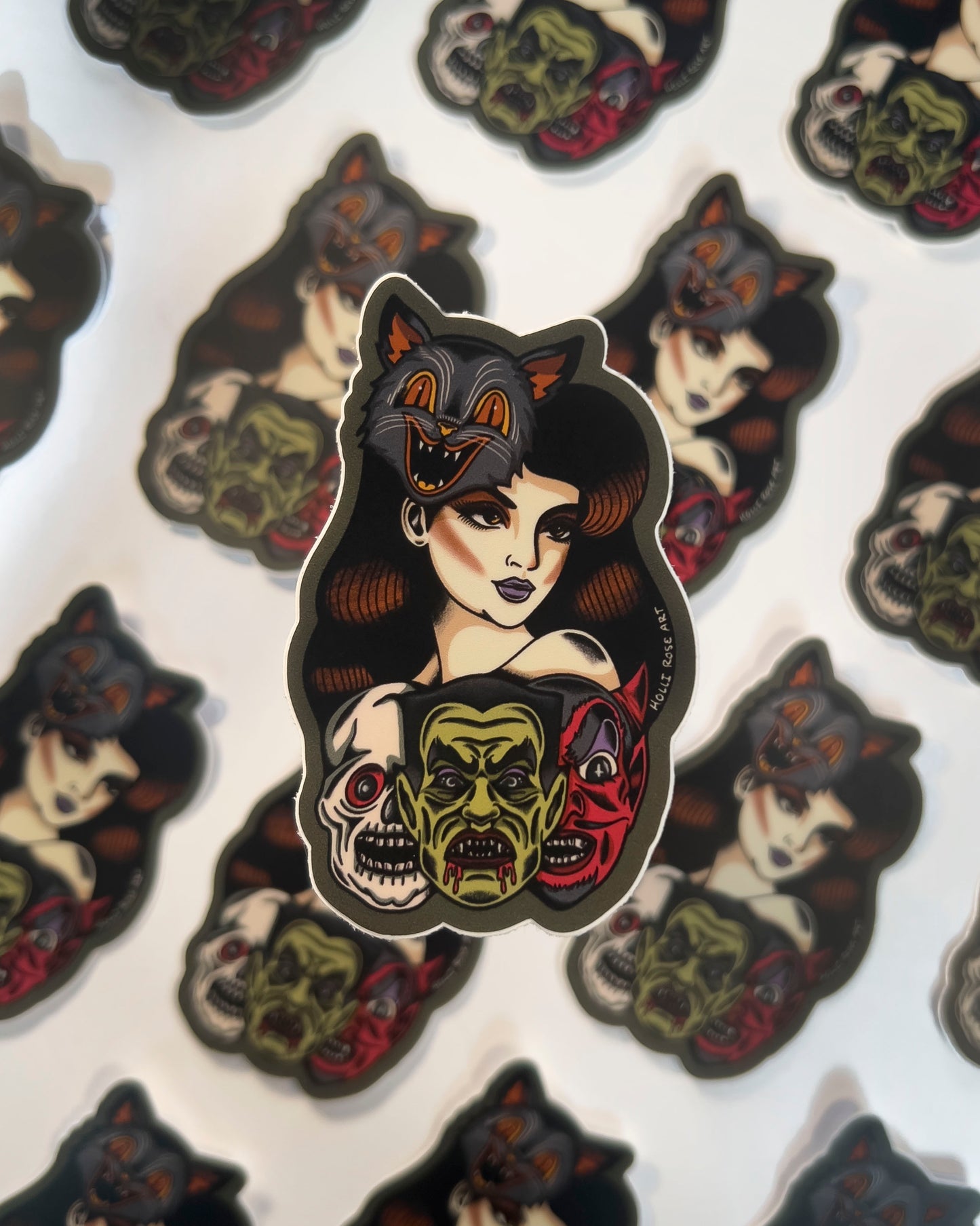 Sticker of a woman wearing a cat mask and monster masks under her