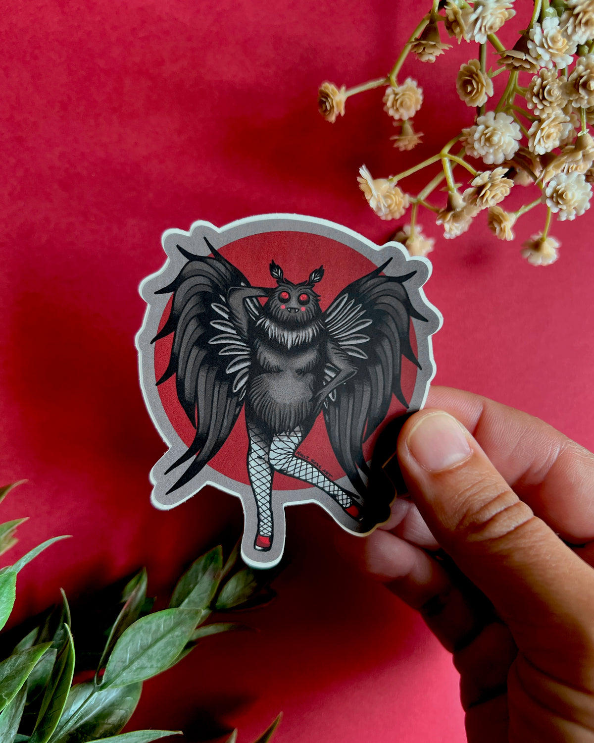 a sticker of a moth ma'am with sexy legs and heels