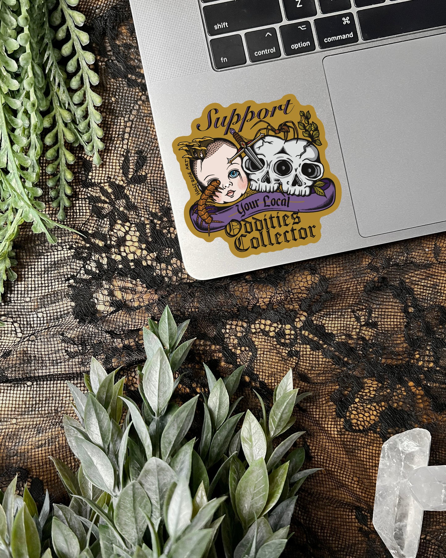 a sticker that says support your local oddities collector with a doll head, double headed skull, and bugs